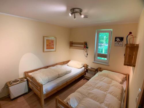 a bedroom with two beds and a window at Ferienhaus Loubier Marne in Marne