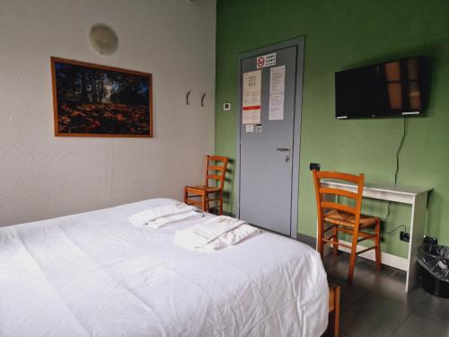 a bedroom with a bed and two chairs and a desk at B&B e Ostello, Parco di Monza, CASCINA COSTA ALTA in Monza
