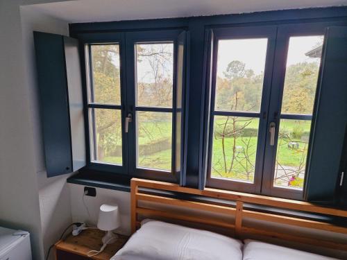 a bedroom with a bed and a window with a view at B&B e Ostello, Parco di Monza, CASCINA COSTA ALTA in Monza