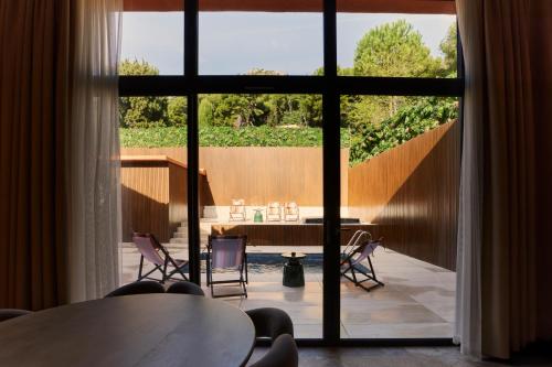 a room with a table and chairs and a large window at EZE BEACH Residence in Éze