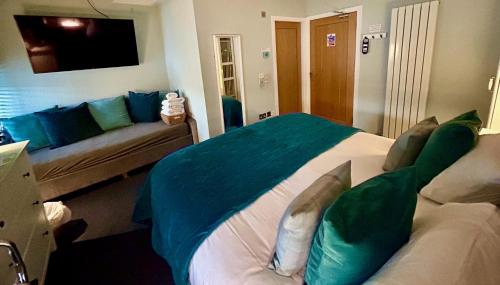 a bedroom with a large bed and a couch at Lochindaal Hotel in Port Charlotte
