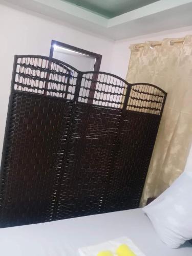 a room with a black fence and a mirror at WARM Tourist Inn in Badian