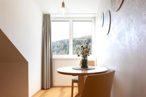 a dining room with a table and a window at Forsthaus Apartments - Die Ruheoase nahe Klaffer in Klaffer am Hochficht