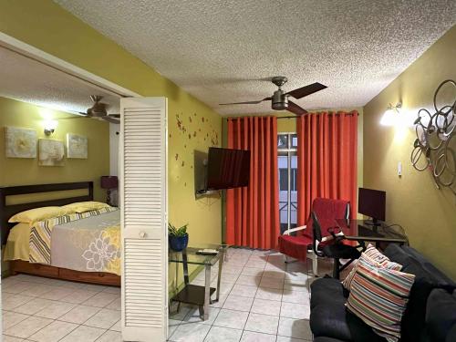 a bedroom with a bed and a couch and a table at Hylton New Kingston 21 in New Kingston