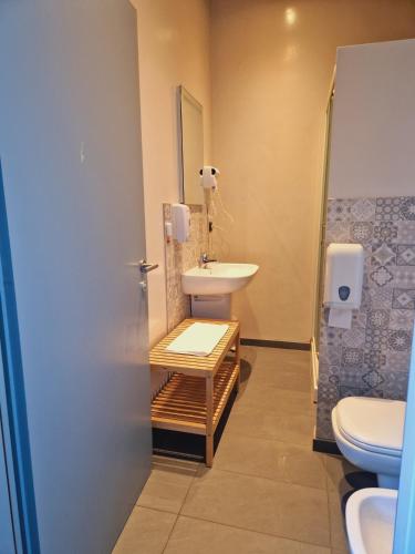 a bathroom with a sink and a toilet at B&B e Ostello, Parco di Monza, CASCINA COSTA ALTA in Monza
