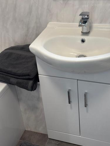 a bathroom with a white sink and a white counter at No 10, Ayr, 130m2, New Decor December 2024, All new entire 3 bedroom garden house in Ayr