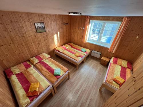 a room with two beds and a window at Penzion pod Vlekem Dolní Morava in Dolní Morava