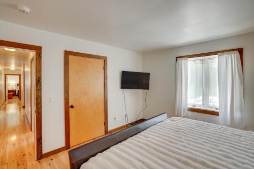 a bedroom with a bed and a television on the wall at 3 Mi to Colgate Lake Mtn-View Home, Deck and Grill! in East Jewett