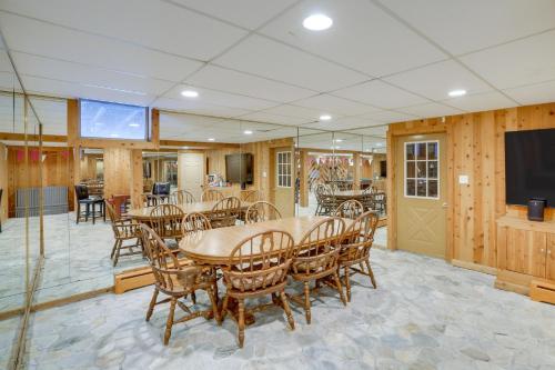a dining room with a table and chairs and a flat screen tv at 3 Mi to Colgate Lake Mtn-View Home, Deck and Grill! in East Jewett