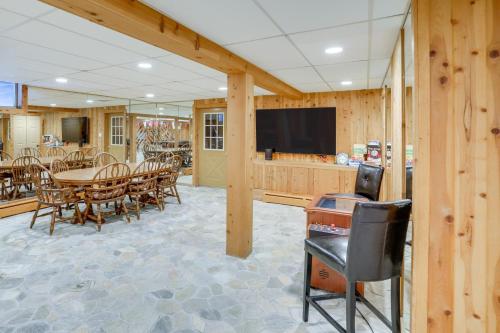 a dining room with a table and chairs and a television at 3 Mi to Colgate Lake Mtn-View Home, Deck and Grill! in East Jewett