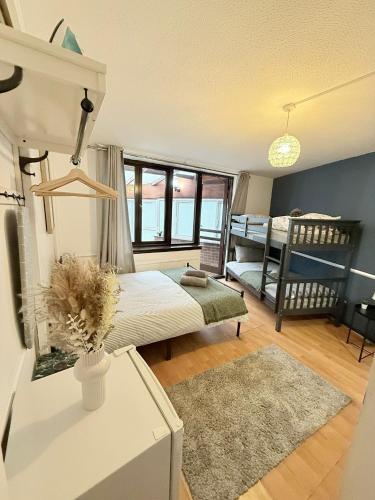 a bedroom with a bed and a crib at Oak Guest Rooms in London