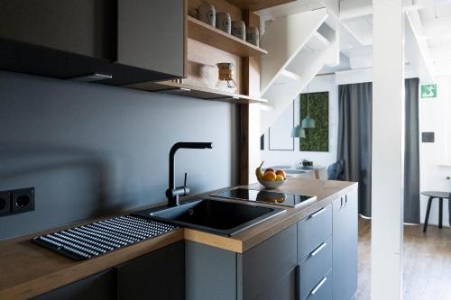 a kitchen with a sink and a counter at Das Nordberg Guesthouse in Garmisch-Partenkirchen