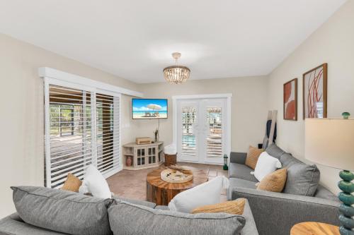 a living room with a couch and a table at Dreamers Hideaway I Waterfront I Direct Access in Naples