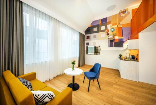 a living room with a couch and a table at lyf Schönbrunn Vienna in Vienna
