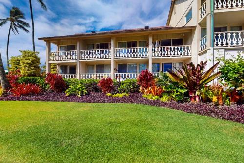 a large building with a lawn in front of it at Islander on the Beach 101 in Kapaa