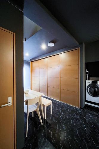 a dining room with a table and a microwave at AnsouHouseメゾネット 大阪ドーム in Osaka