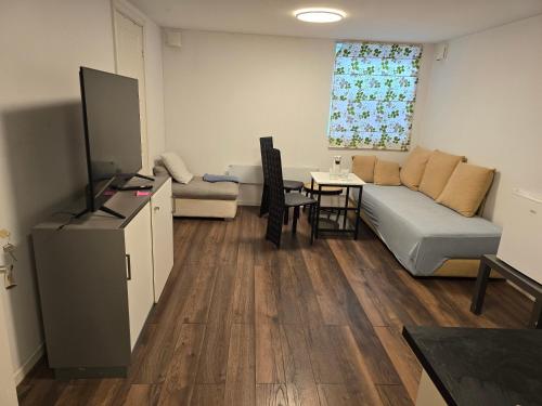 a living room with a couch and a table at Beautiful 2 rooms apartment in kløfta,near oslo airport& oslo in Klofta