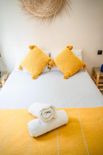 a bedroom with a bed with a towel on it at Med Stay Apartment with amazing Terrace - A2 in Tamraght Ouzdar