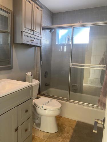 a bathroom with a shower and a toilet and a sink at 90210 Beach House Middle Unit in Hermosa Beach