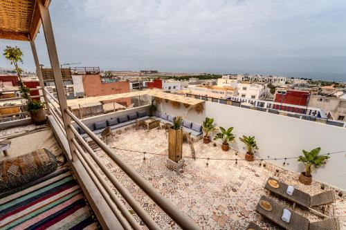 a view from the balcony of a building with plants at Med Stay Apartment with amazing Terrace - A2 in Tamraght Ouzdar