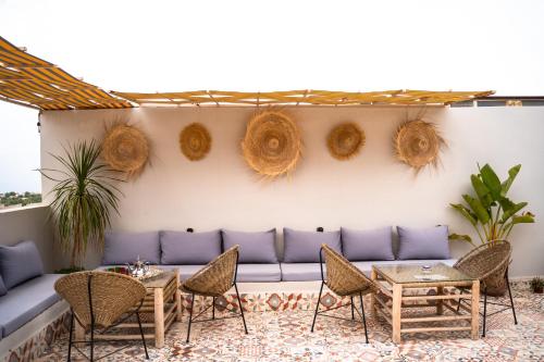 a patio with a couch and chairs and tables at Med Stay Apartment with amazing Terrace - A2 in Tamraght Ouzdar