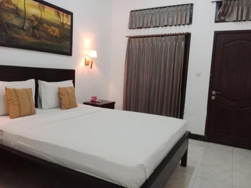a bedroom with a large bed in a room at Ricel homestay in Gili Trawangan