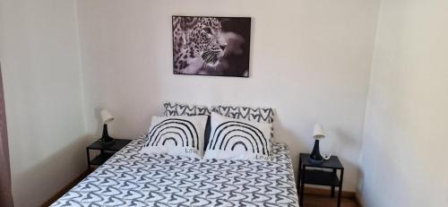 a bedroom with a bed with black and white pillows at Valley Balcony in Enveitg