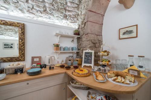 a kitchen with a table with food on it at Bosa Queen House in Bosa
