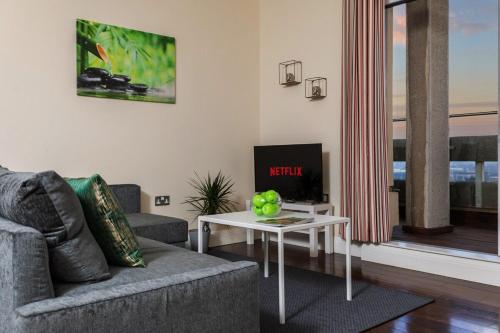 a living room with a couch and a table at Lovely Views 2 Bedroom central apartment in Ashford in Ashford
