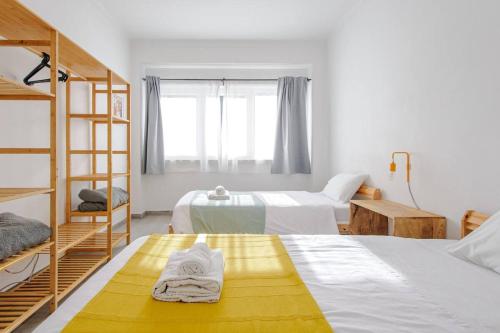 a bedroom with two beds and a bunk bed at Sintra Sweet Apartments III - Free Parking in Sintra