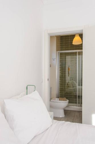 a bedroom with a bed and a bathroom with a toilet at Sintra Sweet Apartments III - Free Parking in Sintra