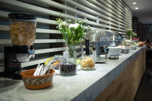 a counter with flowers and other items on it at Anselmo Buenos Aires, Curio Collection by Hilton in Buenos Aires