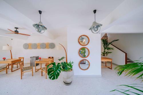 a dining room with tables and chairs and potted plants at 1 BDR Garden Apartment at The Soul, Paje in Paje