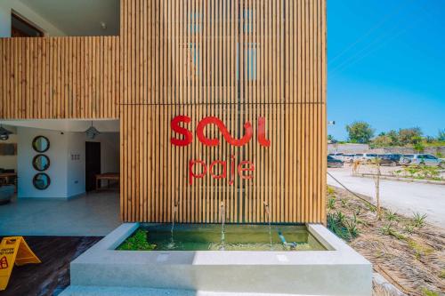 a building with a sign on the side of it at 1 BDR Garden Apartment at The Soul, Paje in Paje