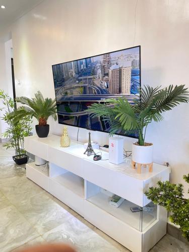 a white entertainment center with a flat screen tv on it at Aberdare Home in Othaya