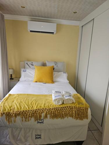 a bedroom with a bed with two towels on it at LPM Guests R in Pretoria