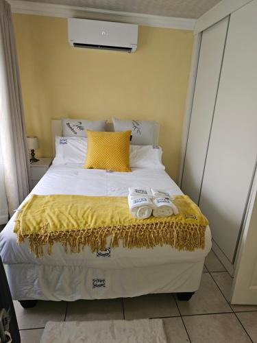 a bedroom with a bed with two towels on it at LPM Guests at 21st in Pretoria