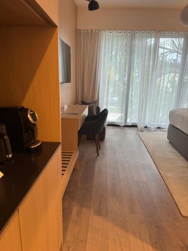 a hotel room with a bed and a desk and a bedroom at The March Hotel in Miami Beach