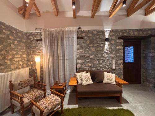 a living room with a couch and a table at Mountain nest B in Elati Trikalon