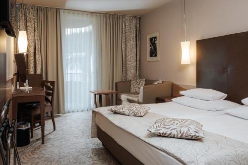 Postel nebo postele na pokoji v ubytování Grand Hotel Sava Superior