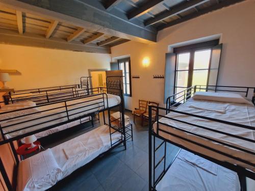a room with three bunk beds in it at B&B e Ostello, Parco di Monza, CASCINA COSTA ALTA in Monza