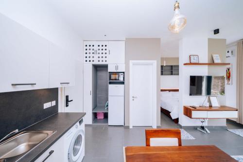 a kitchen and living room with a sink and a bed at 1 BDR Garden Apartment at The Soul, Paje in Paje