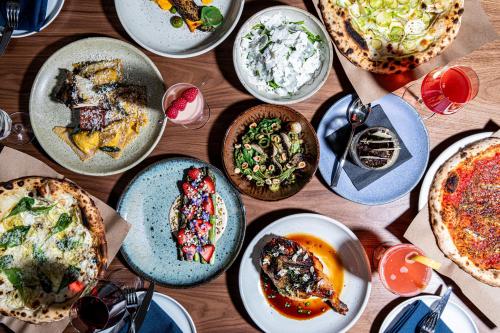 a wooden table with plates of food on it at The Flat Iron Hotel in Asheville