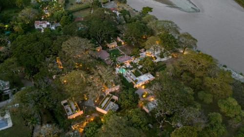 an aerial view of a house on a island next to a river at Arde La Selva in Santa Fe de Antioquia
