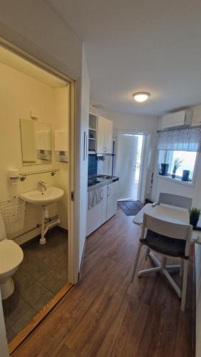 a room with a table and a sink and a kitchen at First Camp Fläsian - Sundsvall in Sundsvall