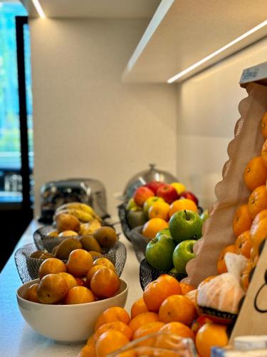 a table with bowls of fruit on top at Servotel Saint-Vincent in Nice