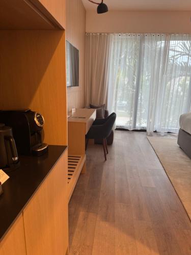 a hotel room with a kitchen and a living room at The March Hotel in Miami Beach