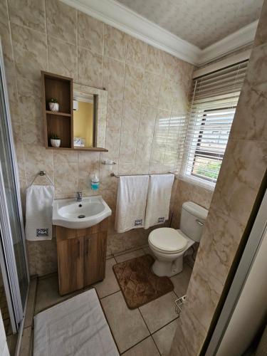 a bathroom with a toilet and a sink at LPM Guests R in Pretoria
