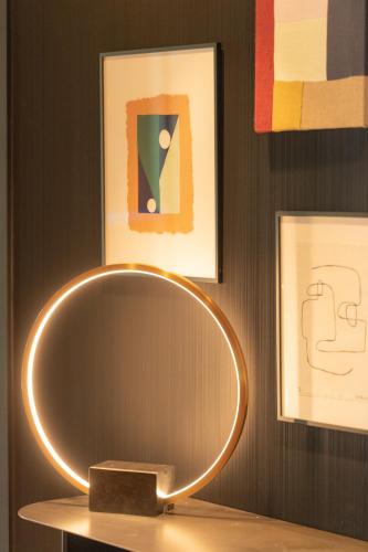 a mirror on a table in a room with paintings at Servotel Saint-Vincent in Nice
