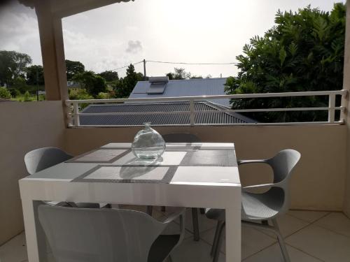 a glass vase sitting on a table on a balcony at Lahaut in Sainte-Rose